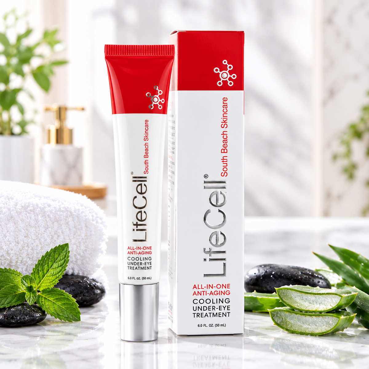LifeCell Cooling Under Eye Treatment shown as a white squeeze tube with a red cap next to its matching white and red retail box, styled on a marble surface with a rolled towel, mint leaves, and aloe vera.