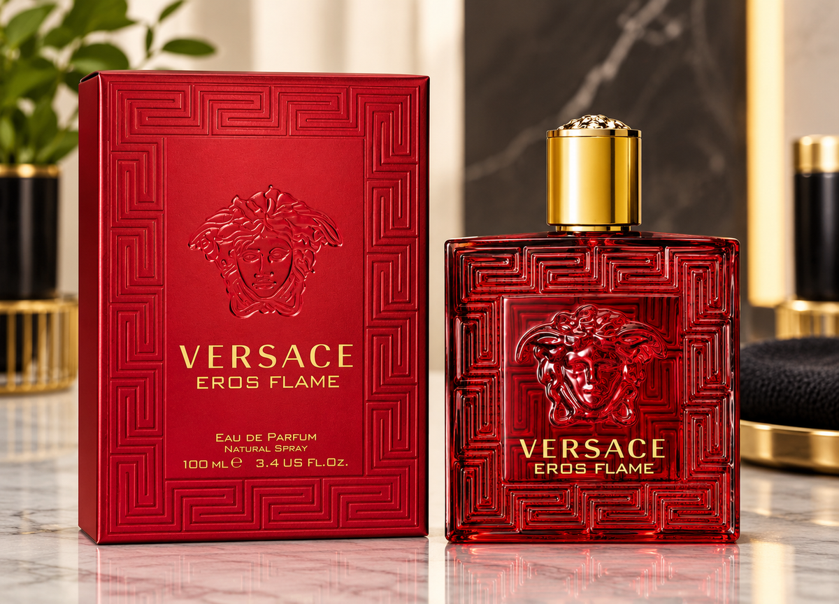 Versace Eros Flame Eau de Parfum bottle and its red packaging box, featuring the embossed Medusa logo and gold lettering, set on a marble surface with a blurred luxury background.